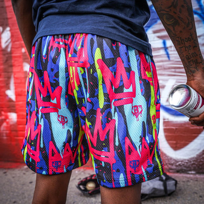 Youth model wearing multi-color youth shorts with โGraffiti Crownโ design