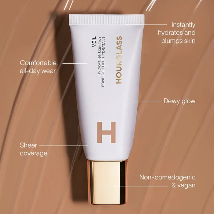 Hourglass Veil Hydrating Skin Tint Foundation in Shade 13, close-up of the bottle with applicator and product details.