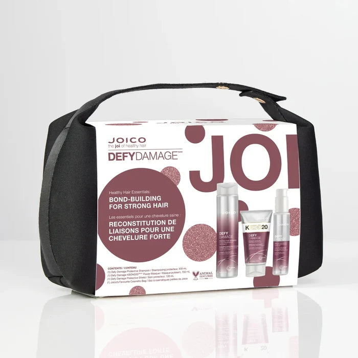 Joico Defy Damage Trio in beauty set with shampoo, conditioner, and treatment bottles on a white background