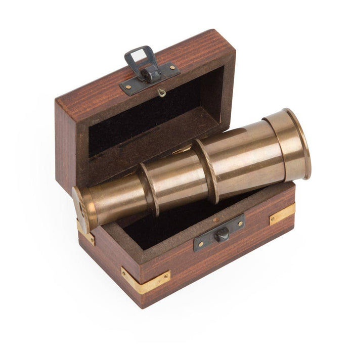 Mini telescope from Ten Thousand Villages with a wooden box, compact and portable for stargazing and exploration.