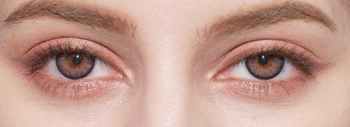 Close-up of a person's face highlighting their hazel eyes, well-groomed eyebrows, and natural makeup, enhanced by NEO Vision Cosmo Violet coloured contact lenses from NEO Vision.