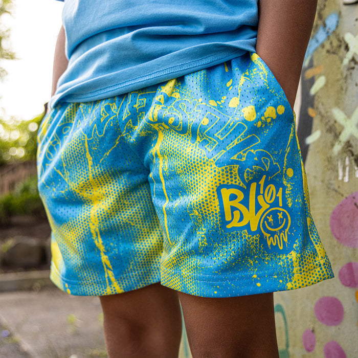 Youth model wearing blue and yellow Retro Graffiti youth shorts