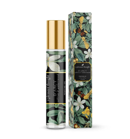 A Pleasant Thought perfume oil by D'ARCY in saffron and amberwood, featuring a sleek glass bottle with a silver cap.
