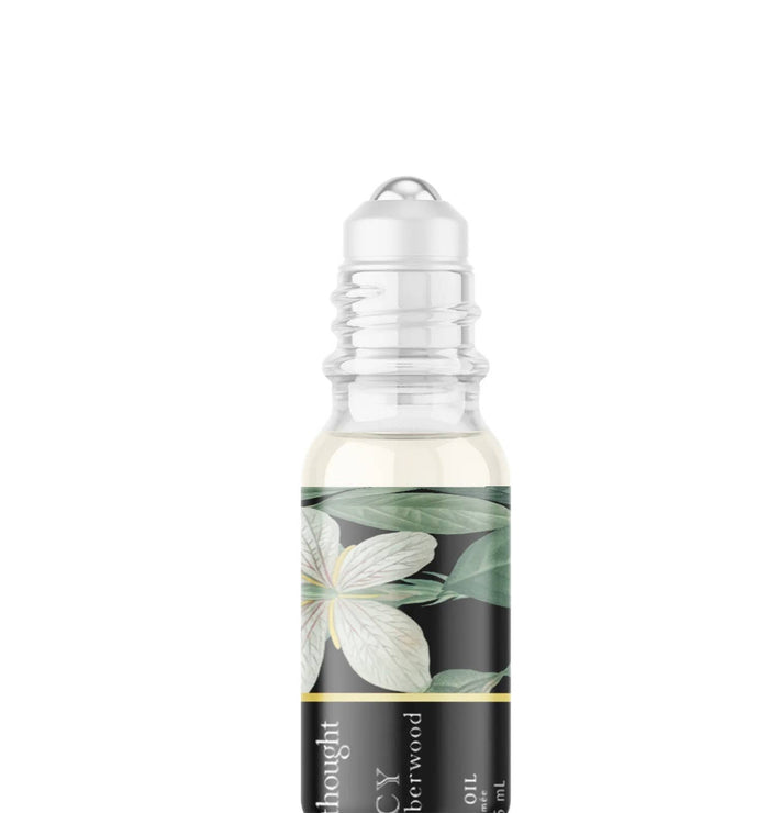 A Pleasant Thought D'ARCY perfume oil with saffron and amberwood, displayed in a sleek glass bottle.