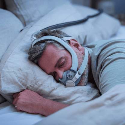 man sleeping soundly wearing the airtouch f30i comfort full face CPAP mask