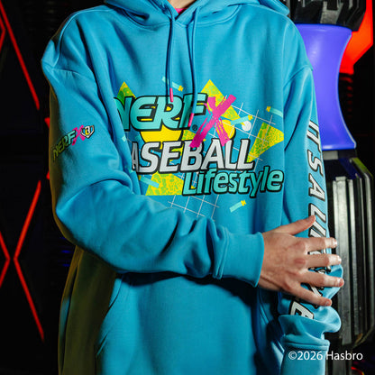 Person wearing a blue hoodie with colorful NERF X Baseball Lifestyle text and graphics, standing against a dark background.
