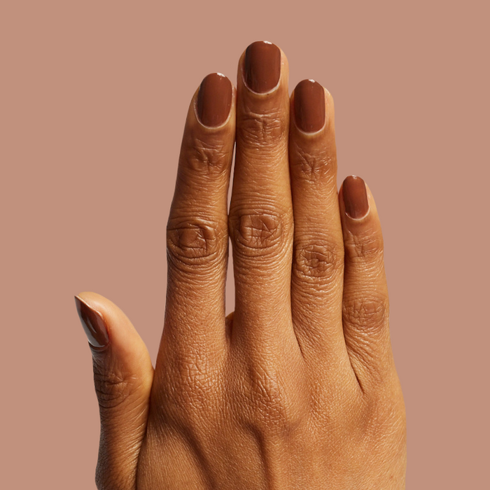 Hand with Americano gel polish in rich coffee brown for a bold, long-lasting at-home manicure look