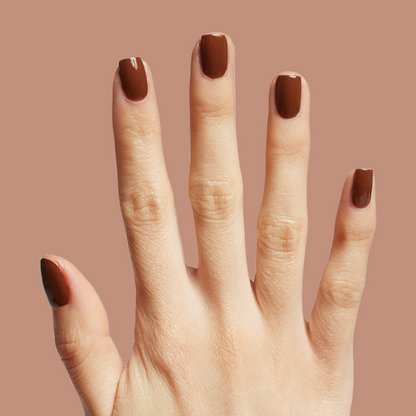 Hand displaying Americano gel polish in rich coffee brown for a bold, polished at-home manicure look