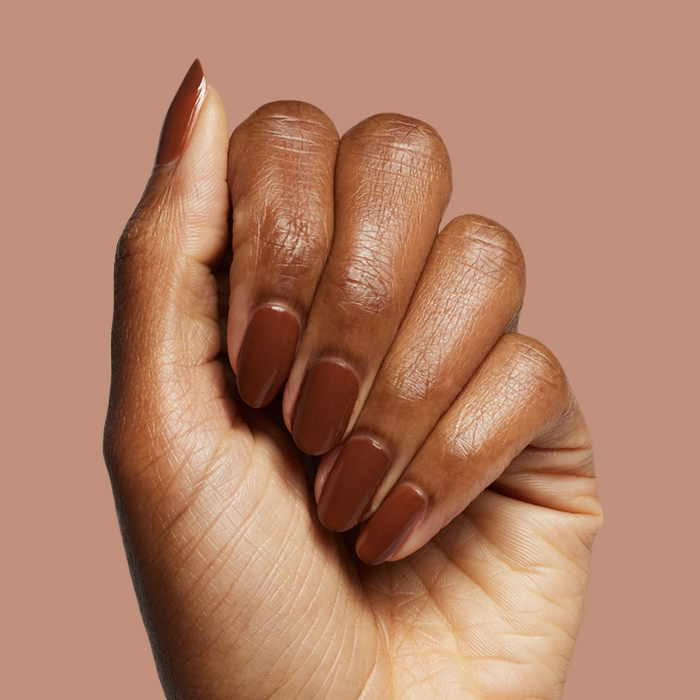 Hand with Americano gel polish in deep coffee brown for a bold, polished manicure at home or on the go