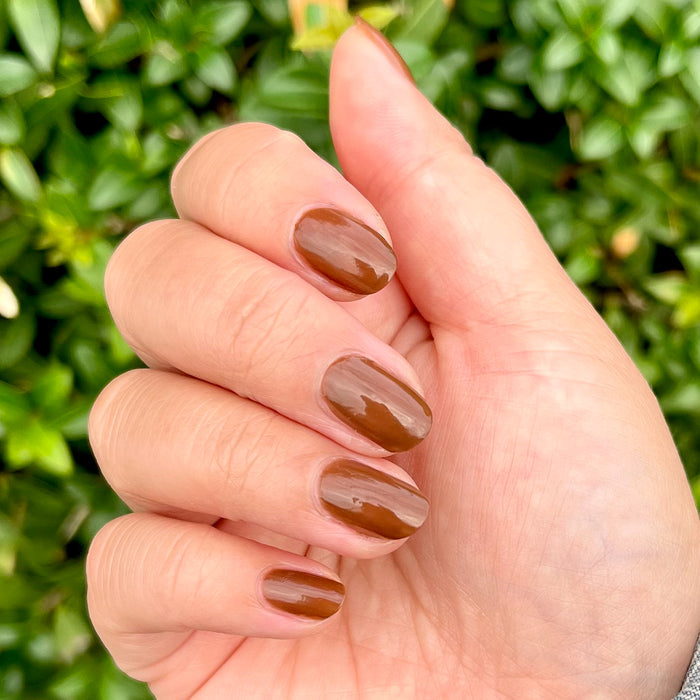Hand with Americano gel polish in warm coffee brown for a smooth, polished long-lasting at-home manicure