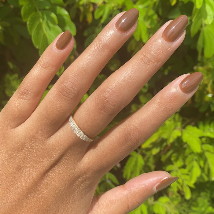 Hand with Americano gel polish in rich coffee brown for a smooth, long-lasting manicure perfect for at-home wear
