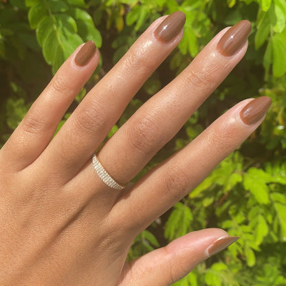Hand with Americano gel polish in rich coffee brown for a smooth, long-lasting manicure perfect for at-home wear