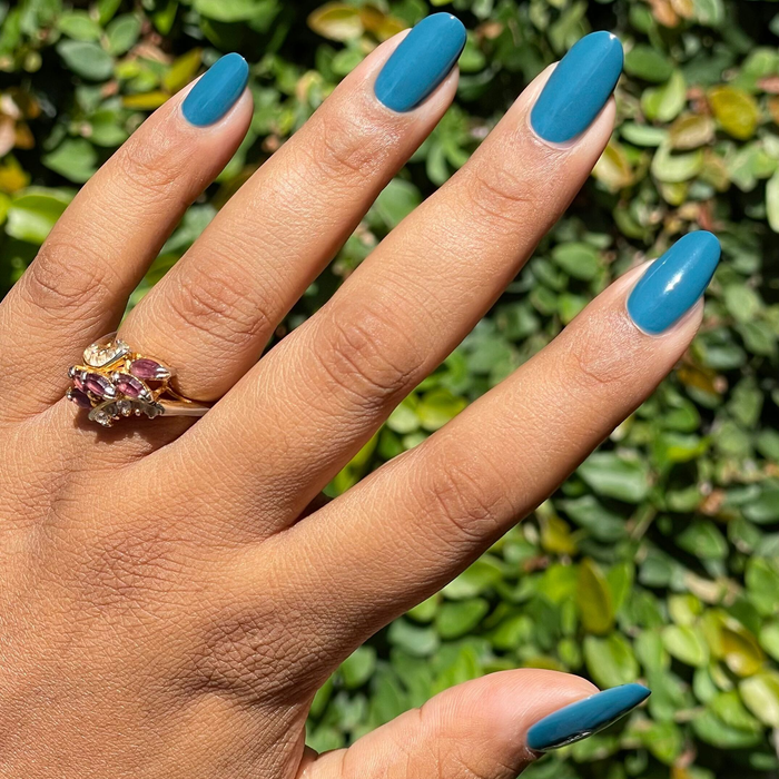 Après Mani smooth deep teal green gel polish on almond-shaped nails for a vibrant at-home manicure by Olive and June