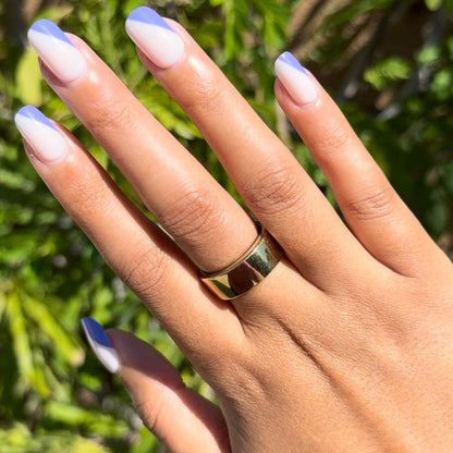 Asymmetrical French | Short | Squoval - Tab Press-On nails with indigo tipped diagonal design on natural base on hand outdoors