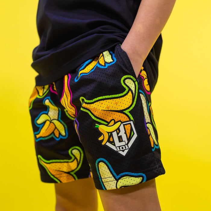 Youth model wearing black Banana Neon youth shorts