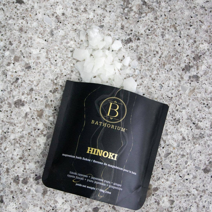 Bathorium Hinoki Magnesium Flake Bath Soak in a container, showcasing the natural magnesium flakes for relaxing bath experiences.
