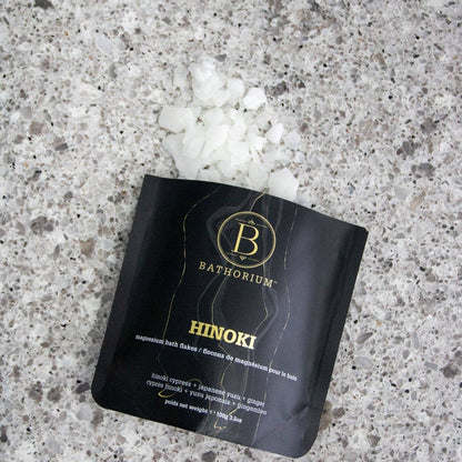 Bathorium Hinoki Magnesium Flake Bath Soak in a container, showcasing the natural magnesium flakes for relaxing bath experiences.