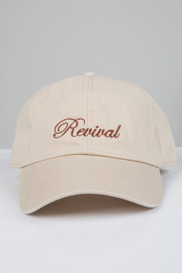 Beige cap with 'Revival' embroidery on a light gray background