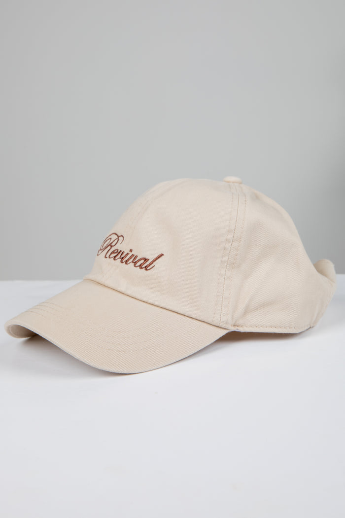 Beige cap with 'Revival' embroidery on a light gray background