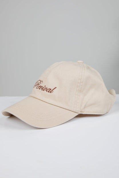 Beige cap with 'Revival' embroidery on a light gray background