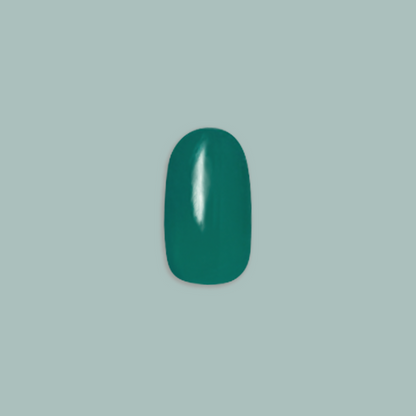 Besties - Press-On | Short | Round showing single deep emerald green short round false nail on muted teal background