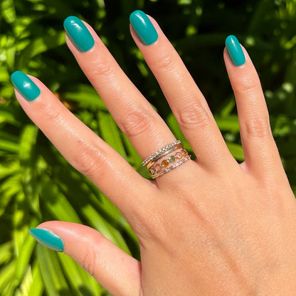 Besties - Press-On | Short | Round showing hand with bright teal short round press-on manicure outdoors with leafy background