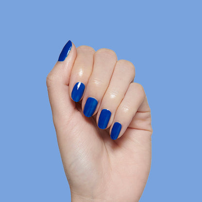 Hand with medium-length nails polished in vibrant Blueberry Muffin cobalt blue long-lasting nail polish