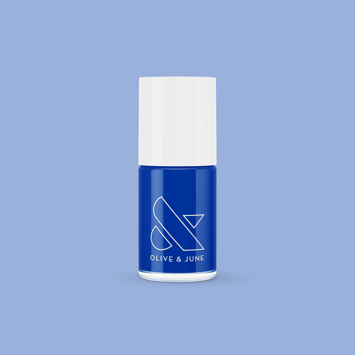 Blueberry Muffin cobalt blue long-lasting nail polish bottle with white cap against soft blue background