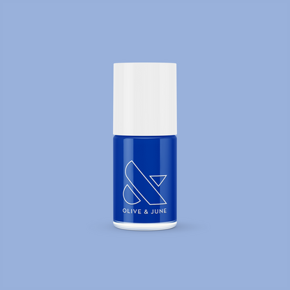 Blueberry Muffin cobalt blue long-lasting nail polish bottle with white cap against soft blue background