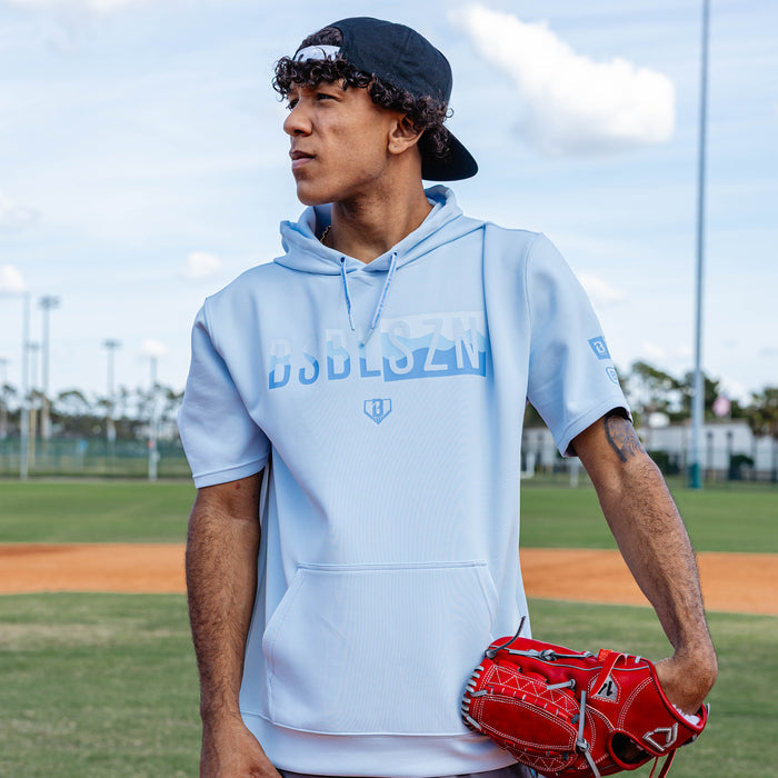 Adult model wearing powder blue and wavy BSBL-SZN short sleeve hoodie
