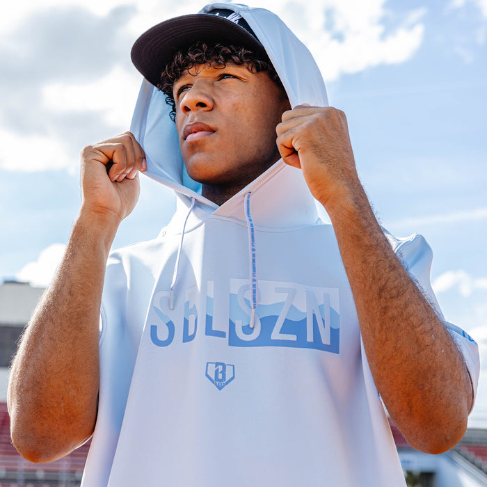Adult model wearing powder blue and wavy BSBL-SZN short sleeve hoodie