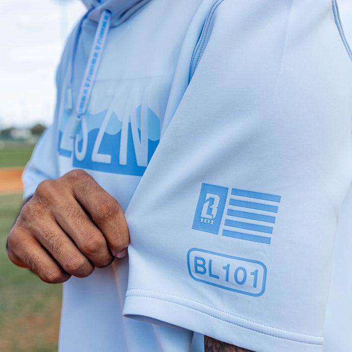 Adult model wearing powder blue and wavy BSBL-SZN short sleeve hoodie