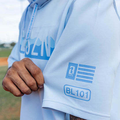 Adult model wearing powder blue and wavy BSBL-SZN short sleeve hoodie