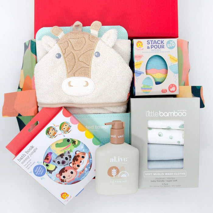 A baby hamper gift set including a giraffe hooded towel, bath toys, a bath book, and wash items presented in a red box. Price: 135