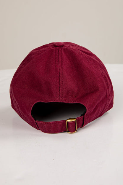 Maroon cap with a gold buckle on a white background