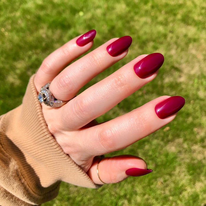 Cabernet | Medium | Oval - Tab Press-On showing glossy medium oval nails in rich dark plummy red for an easy at home mani