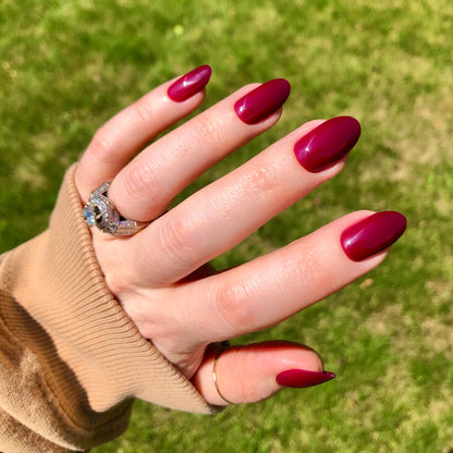 Cabernet | Medium | Oval - Tab Press-On showing glossy medium oval nails in rich dark plummy red for an easy at home mani
