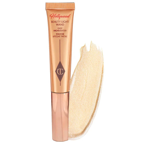 Charlotte Tilbury Beauty Highlighter Wand in Spotlight, a luminous liquid highlighter with a sleek applicator for a radiant glow.