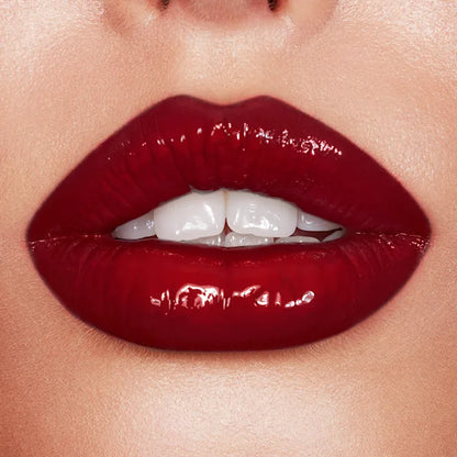 Charlotte Tilbury Latex Love Video Vixen beauty product featuring a model wearing vibrant latex makeup in a video scene.
