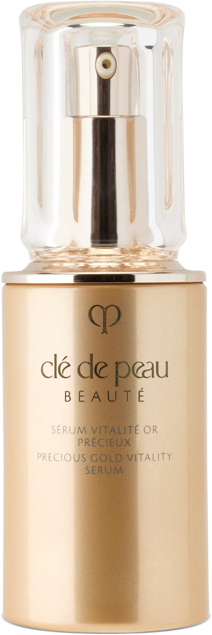 Bottle of CLÉ DE PEAU BEAUTÉ Precious Gold Vitality Serum 40 mL, unopened, with elegant packaging visible.