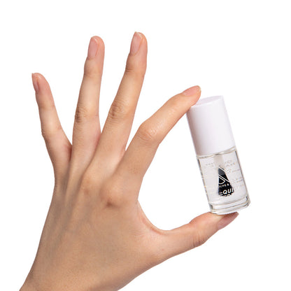 Hand holding a clear bottle of Crystal nail polish showcasing a glossy natural manicure on white background