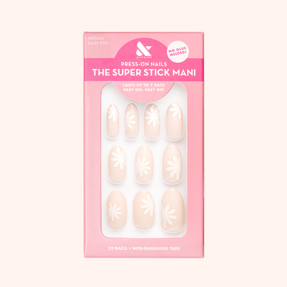 Daisy Pop | Medium | Oval - Tab Press-On showing neutral medium oval nails with large white daisy designs for easy at home mani