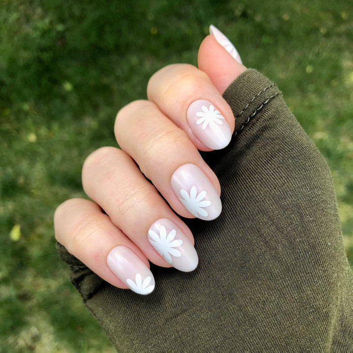 Daisy Pop | Medium | Oval - Tab Press-On showing neutral oval press-on nails with white daisy designs for an easy at home mani