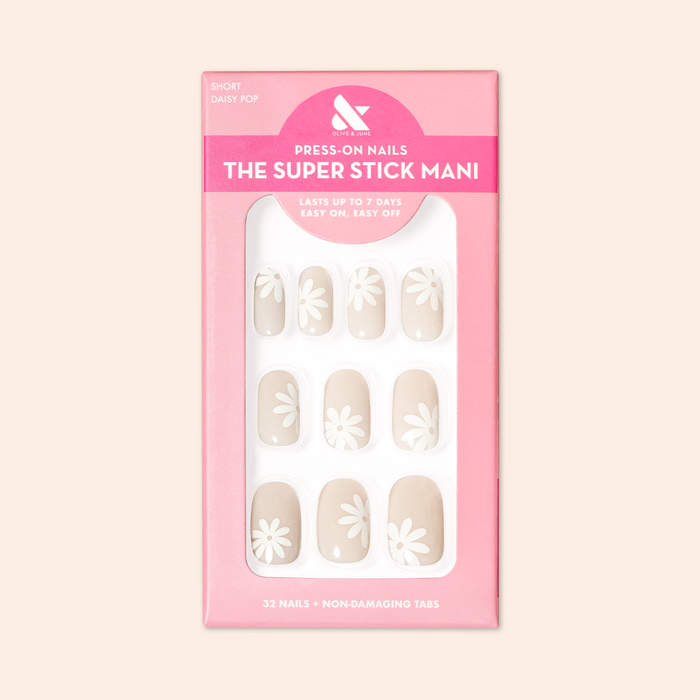 Daisy Pop | Short | Round - Tab Press-On nails in neutral shades with large white daisy designs in pink packaging