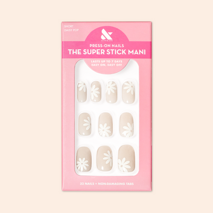 Daisy Pop | Short | Round - Tab Press-On nails in neutral shades with large white daisy designs in pink packaging