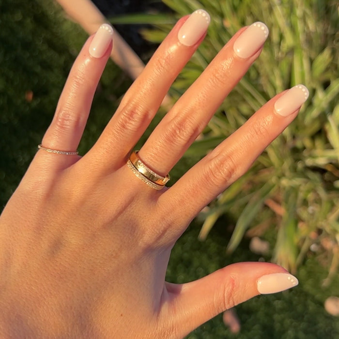 Dotted French | Short | Round - Tab Press-On nails in natural light showing short round false nails with white dotted French tips on hand