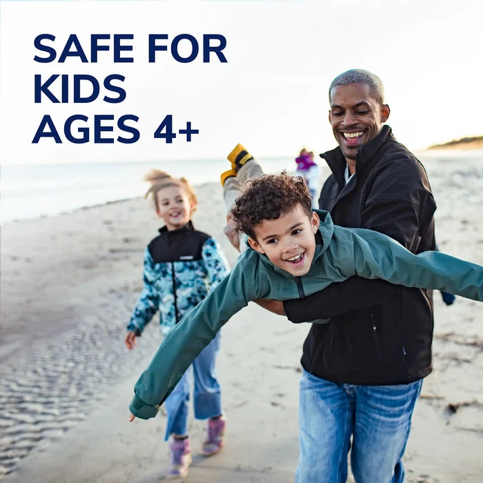 Family on the beach with wart remover 'safe for kids' promotional banner
