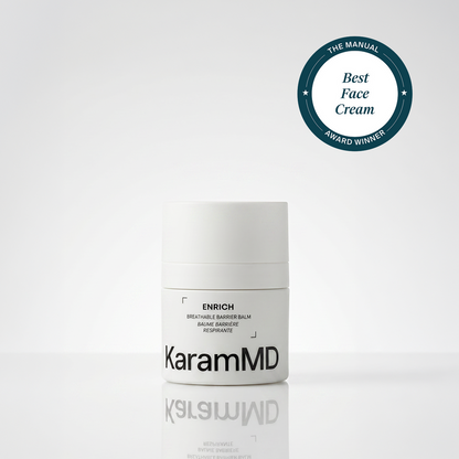 A white cylindrical jar of KaramMD Enrich Breathable Barrier Balm on a light gray reflective surface, with a dark teal circular award badge in the top right reading 'The Manual Best Face Cream Award Winner'.