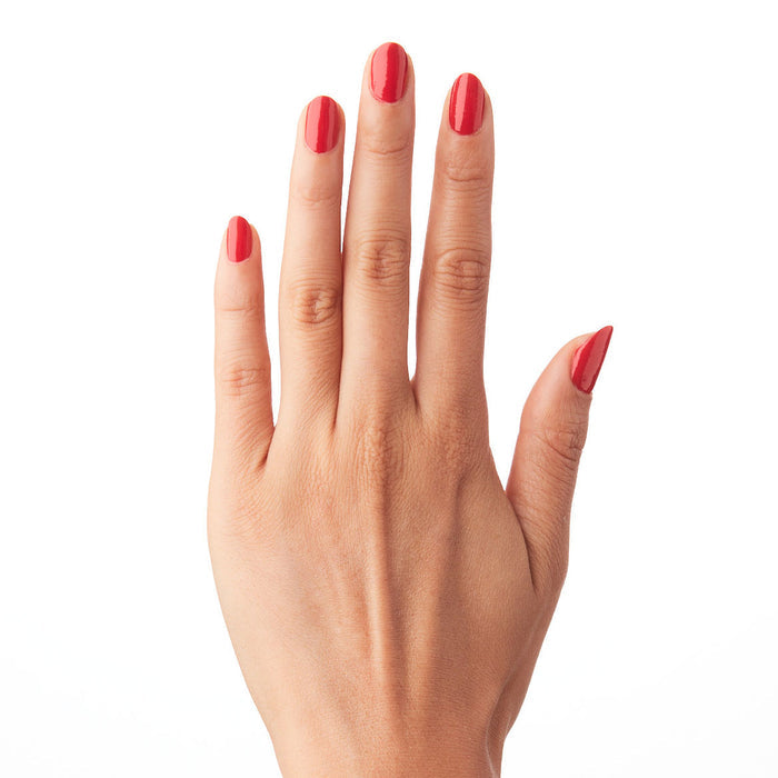 Hand with nails painted in ES polish showing a classic crimson red long-lasting manicure on natural skin tone