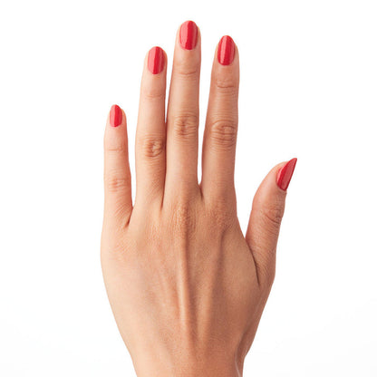 Hand with nails painted in ES polish showing a classic crimson red long-lasting manicure on natural skin tone